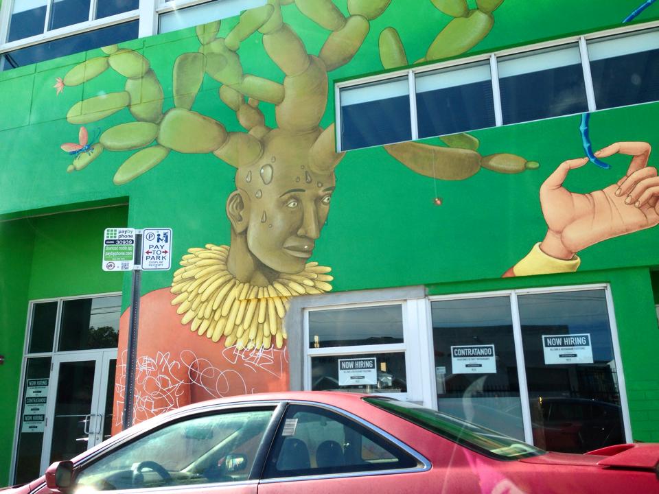 A graffiti painting of a man with a cactus growing out of his head